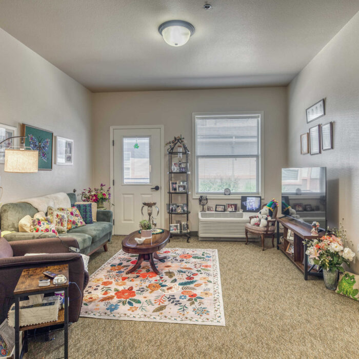 Charming senior apartment living room with floral accents and personal decor.