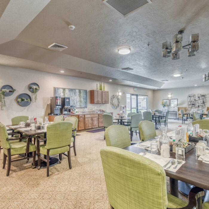 Grace Assisted Living dining room with green chairs and modern decor
