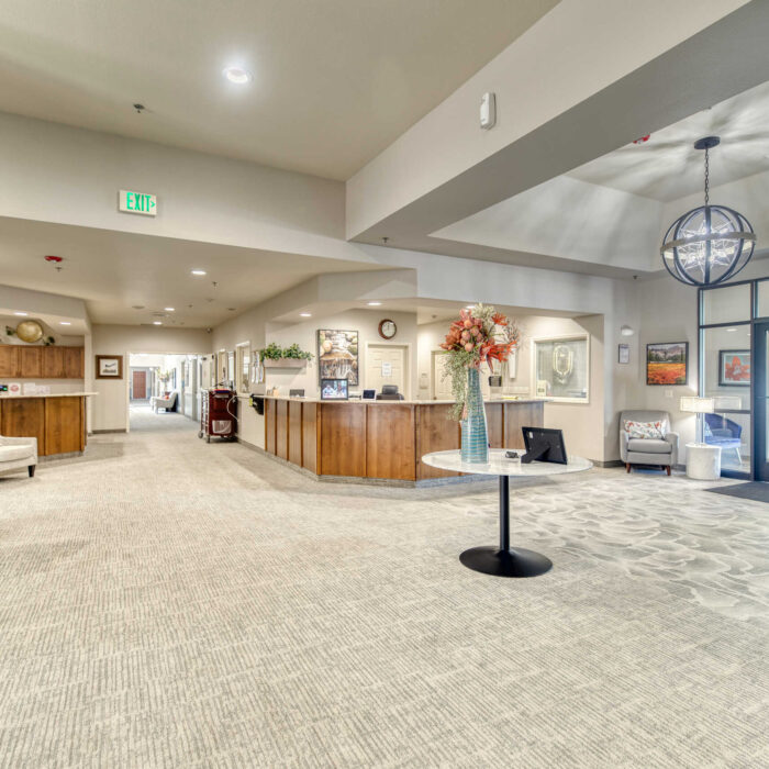 Lobby entrance with front desk, floral decor, and bright natural lighting in Englefield Boise