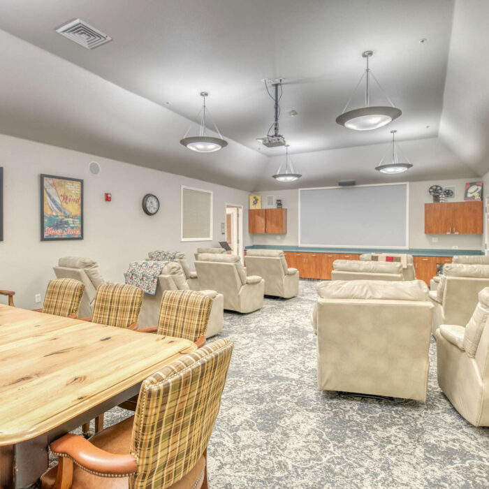 Comfortable movie theater room at Grace Assisted Living Meridian with plush recliners.