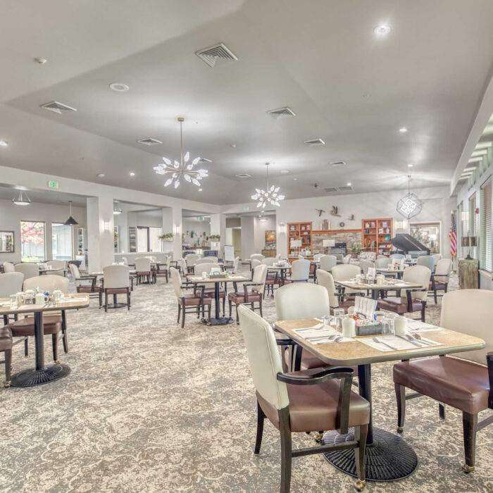 Elegant dining area with modern lighting and comfortable seating at Grace Assisted Living Meridian.