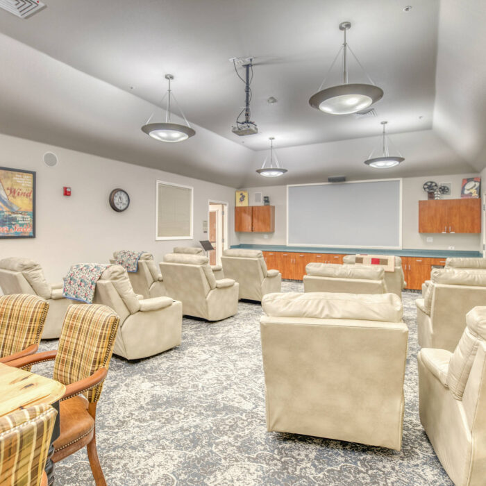 Plush theater-style seating in the media room at Grace Assisted Living in Meridian.