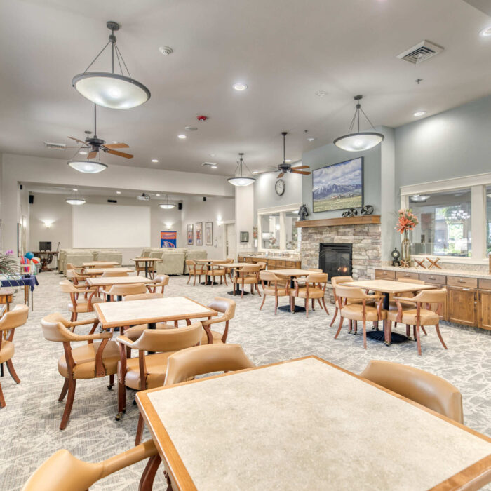 Multipurpose dining and community room with stone fireplace and cozy decor